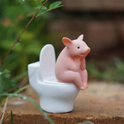 cartoon pig sitting on toilet desktop ornament - MRSLM