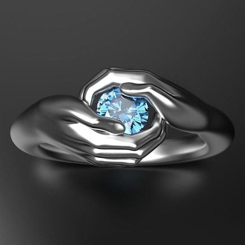 Blue crystal zircon hands embrace ring, view 2 - MRSLM